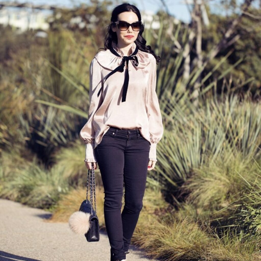 photo of person with pink blouse and black jeans