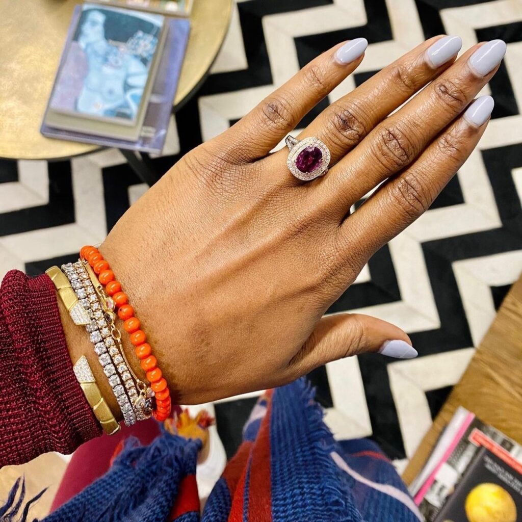 hand wearing a diamond and ruby ring