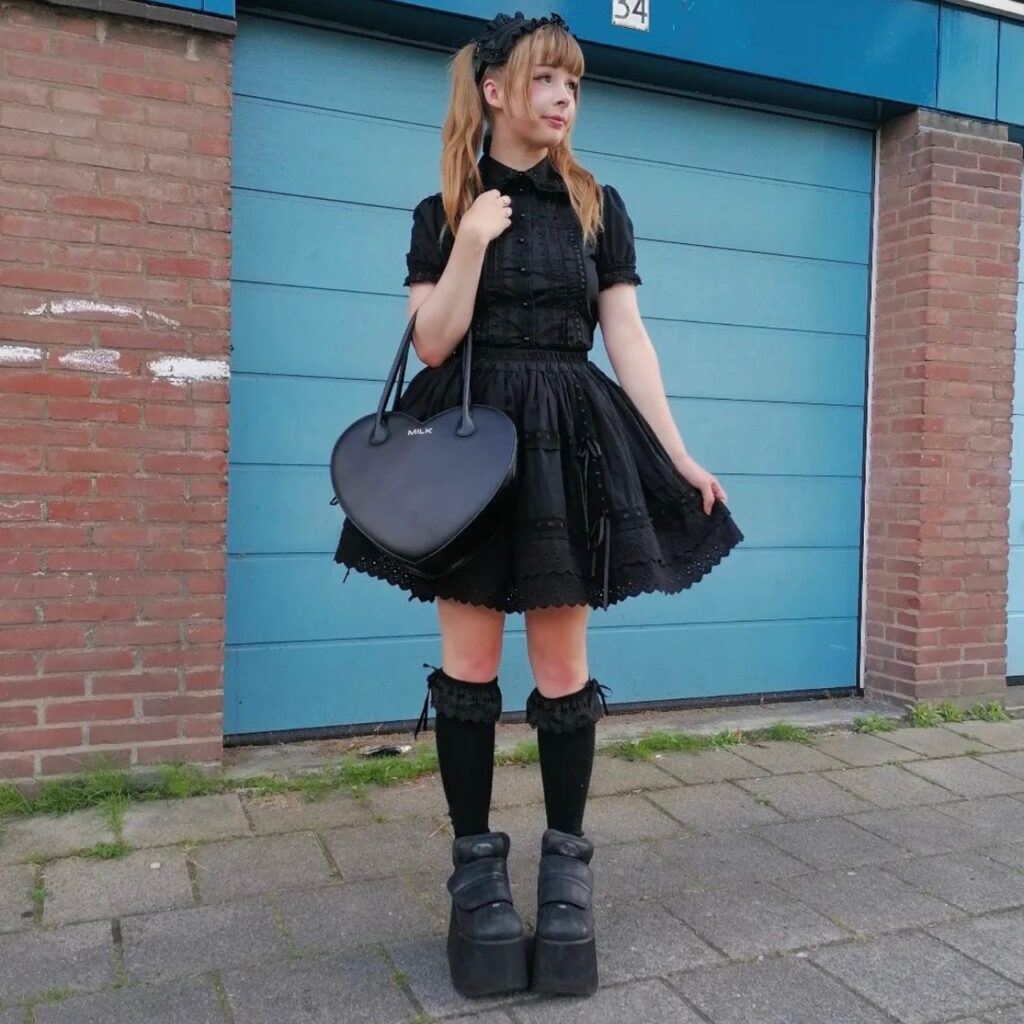 woman wearing all-black outfit with tall boots