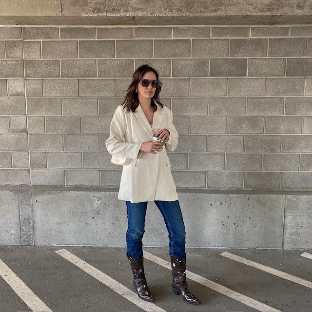 woman wearing oversized cream-colored blazer with jeans and cowboy boots