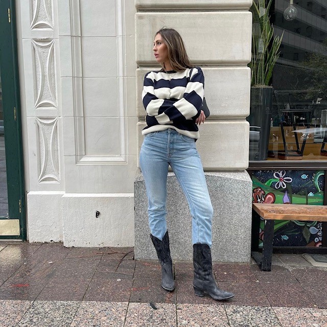 woman wearing striped sweater and light jeans