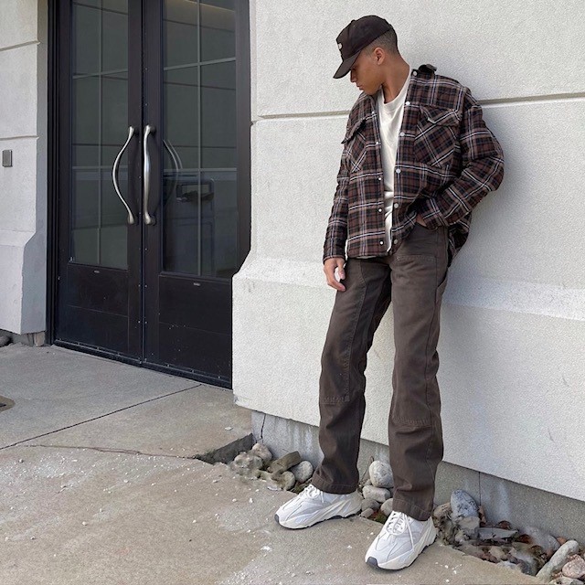 man with flannel shirt, t-shirt, and cargo pants