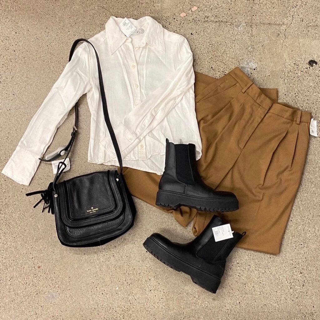 cream blouse, brown-gold pants, black handbag, and boots