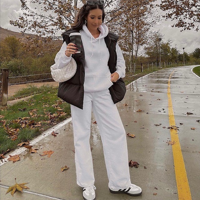 woman wearing one with white sweatsuit with sneakers