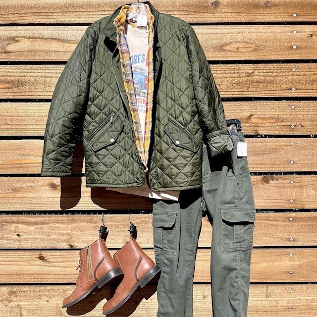 quilted green jacket, flannel shirt, cargo pants, and leather ankle boots