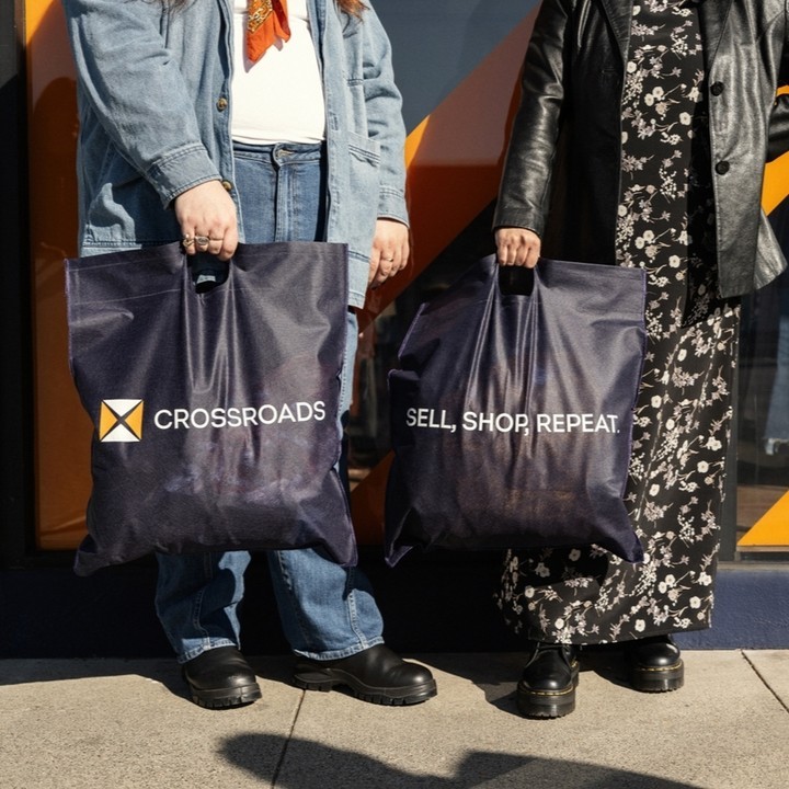 two people holding Crossroads shopping bags