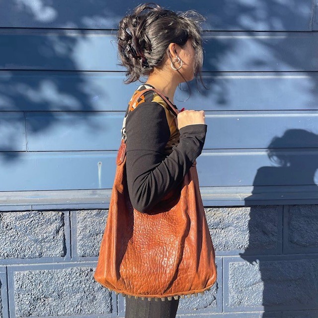 woman with a brown leather bag