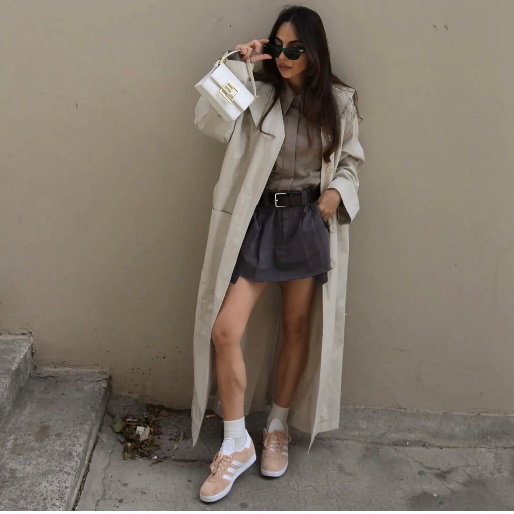 girl with pleated version with a blouse and long trench coat