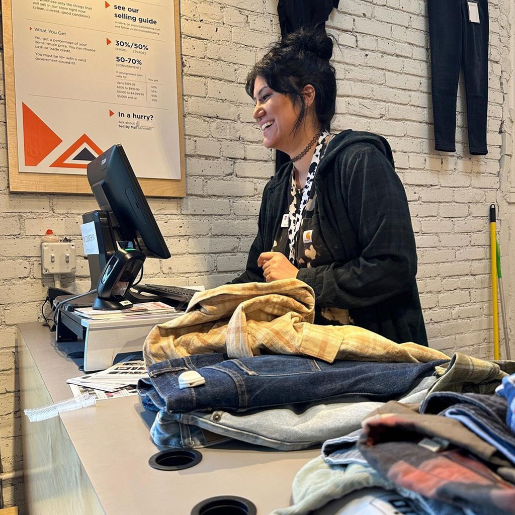 buyer giving cash for clothes at a Crossroads selling counter