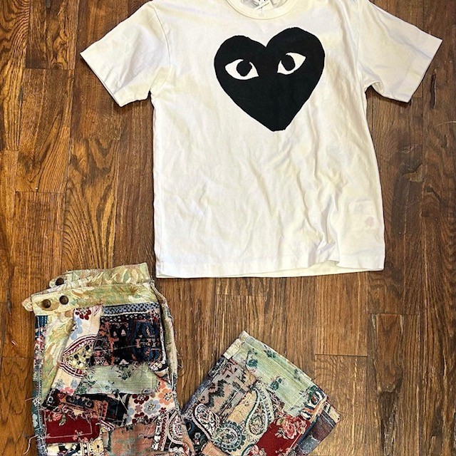 men's clothing resale items: white graphic t-shirt and scrapwork pants