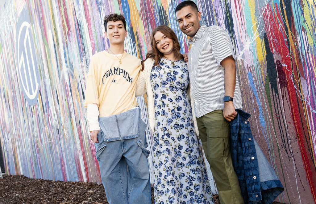 Models wearing spring fashion standing in front of colorful mural