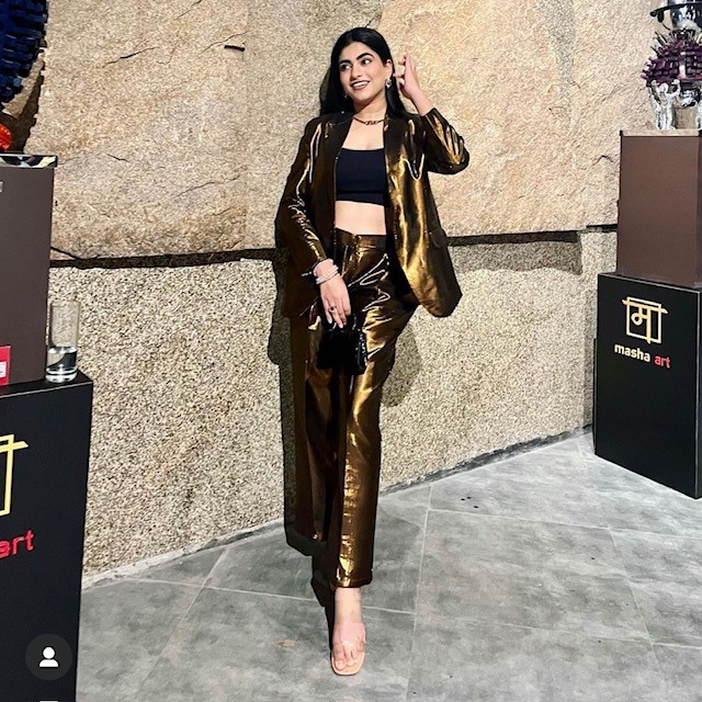 woman in a gold metallic fashion suit