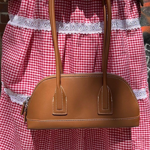 example of micro bags: a tan leather bag with long handles