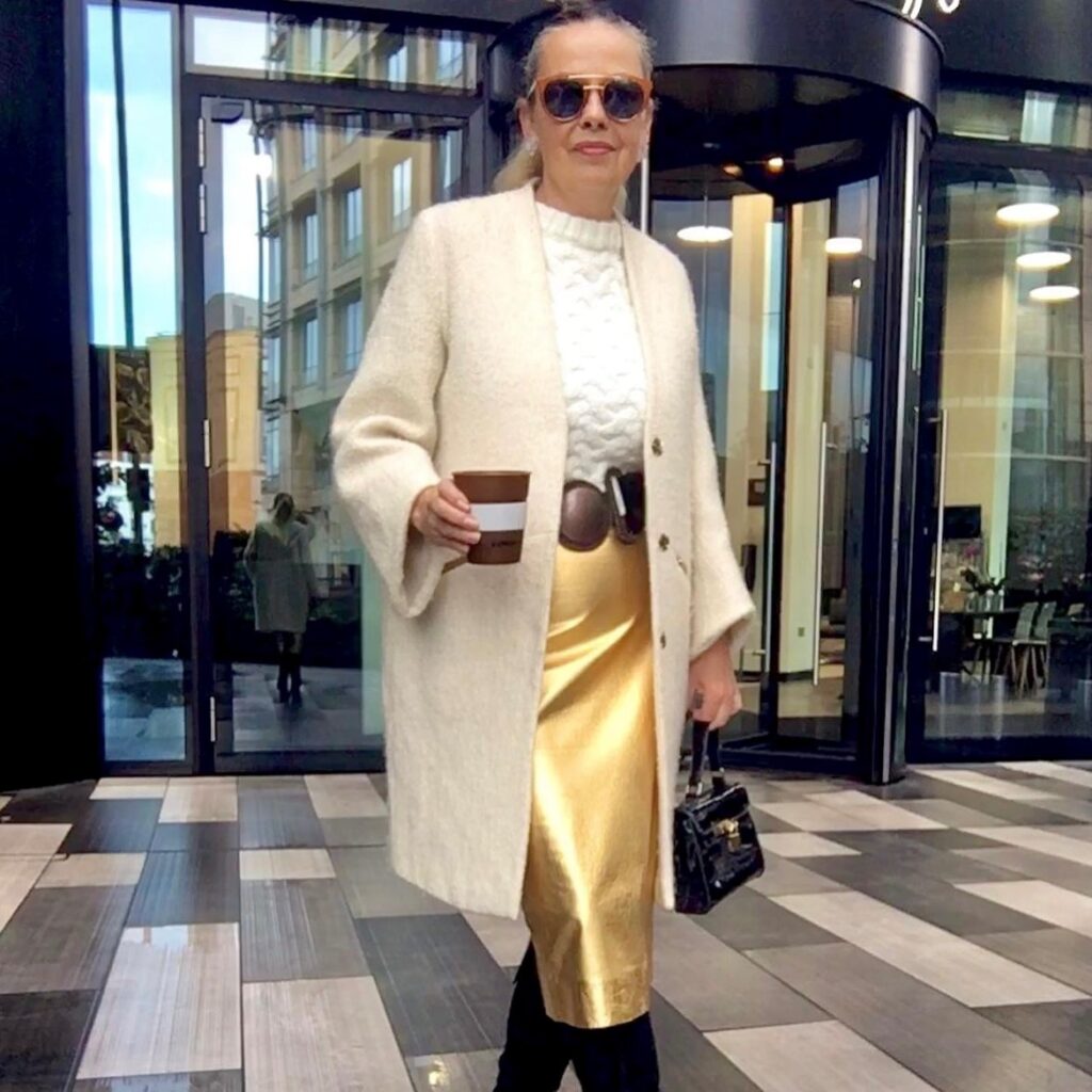 woman in gold metallic fashion pencil skirt with cream-colored sweater