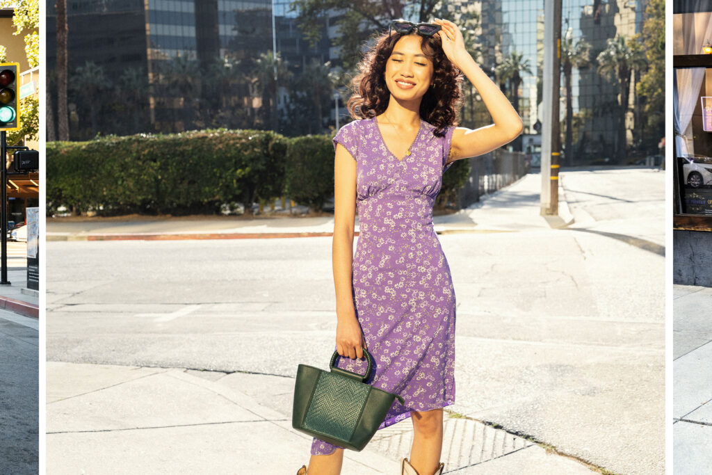 One model wearing a purple floral dress holding a green purse
