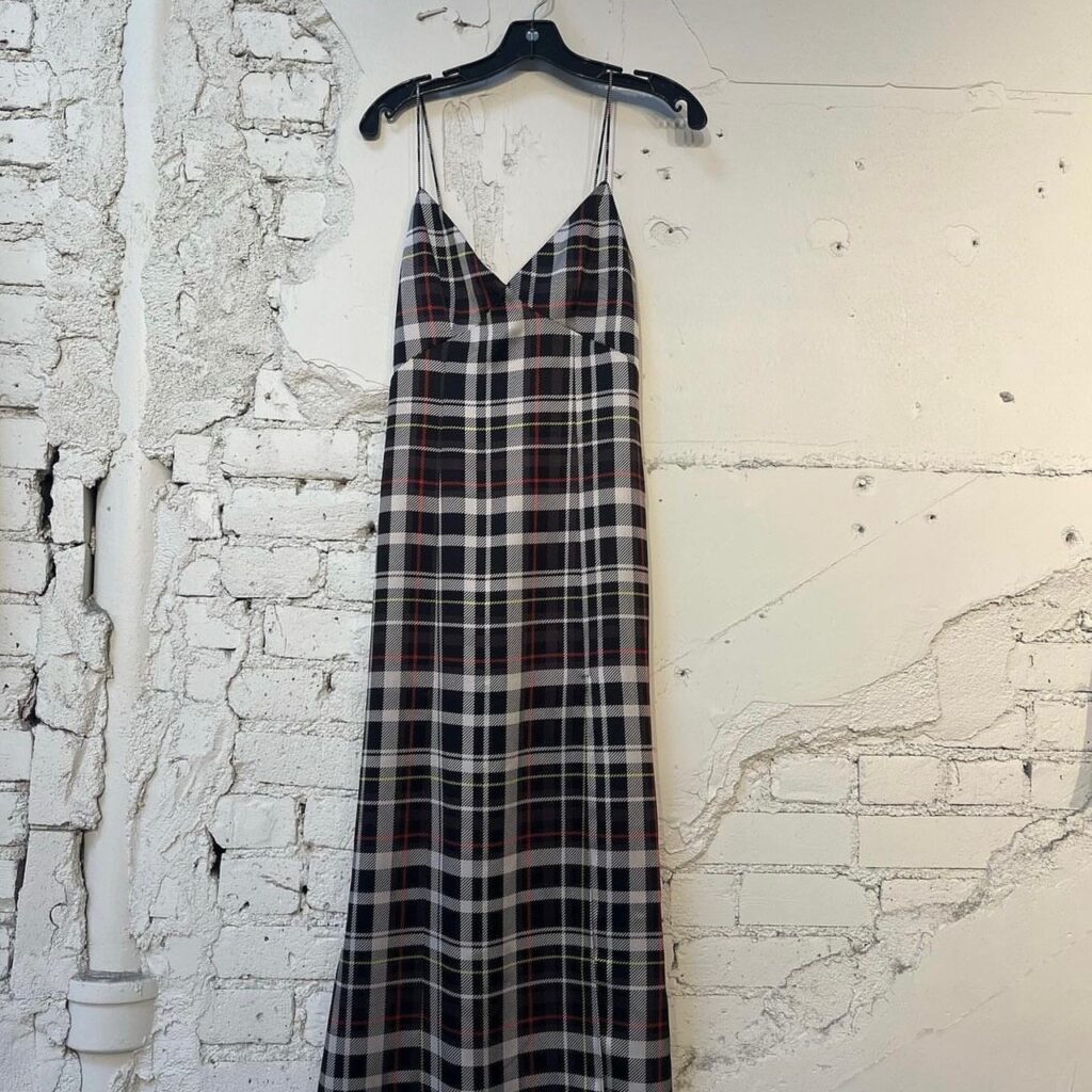 plaid slip dress hanging from a hook 