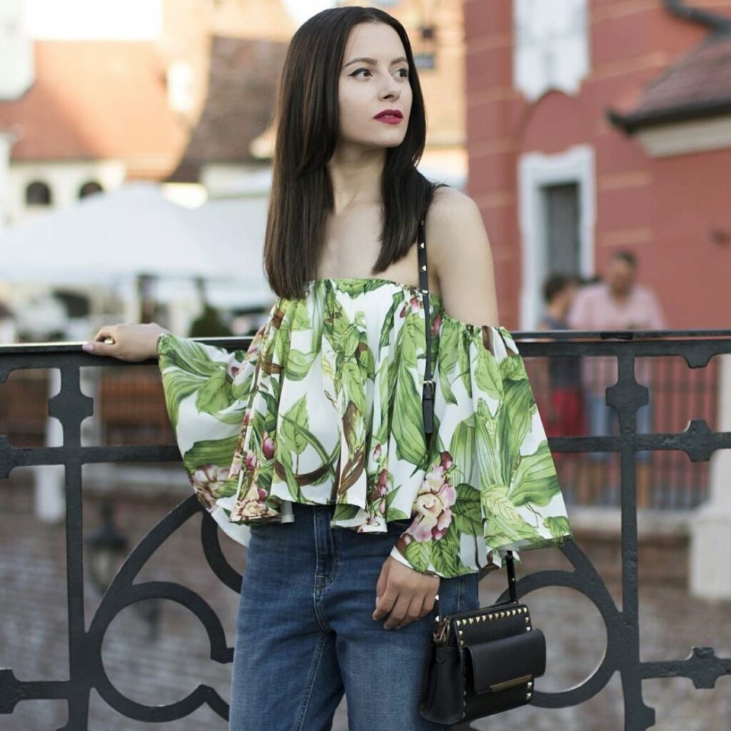 woman wearing a tropical print off-the-shoulder top