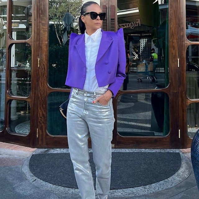 woman in silver pair with white blouse and purple cropped jacket