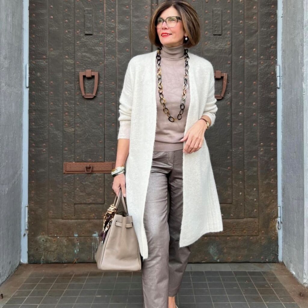 woman in metallic jeans with turtleneck and long cardigan