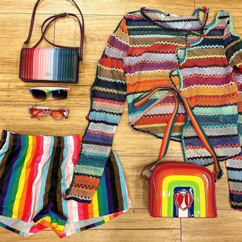 flat lay of clothing in rainbow colors, making up Pride looks