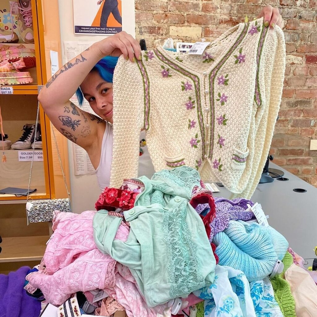 buyer holding up a piece of clothing