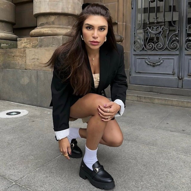 woman wearing a black pair with shorts and a blazer