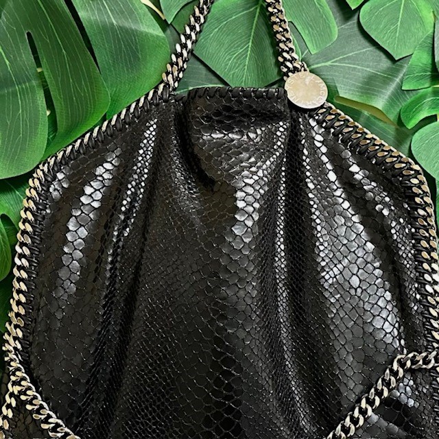 Close-up of vintage designer Stella McCartney bag in black with silver chain