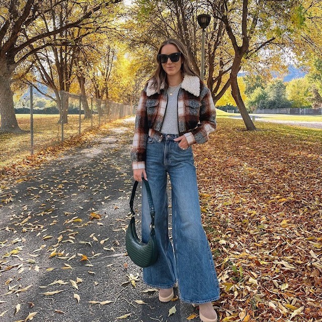 woman in plaid jacket with t-shirt and wide-leg jeans