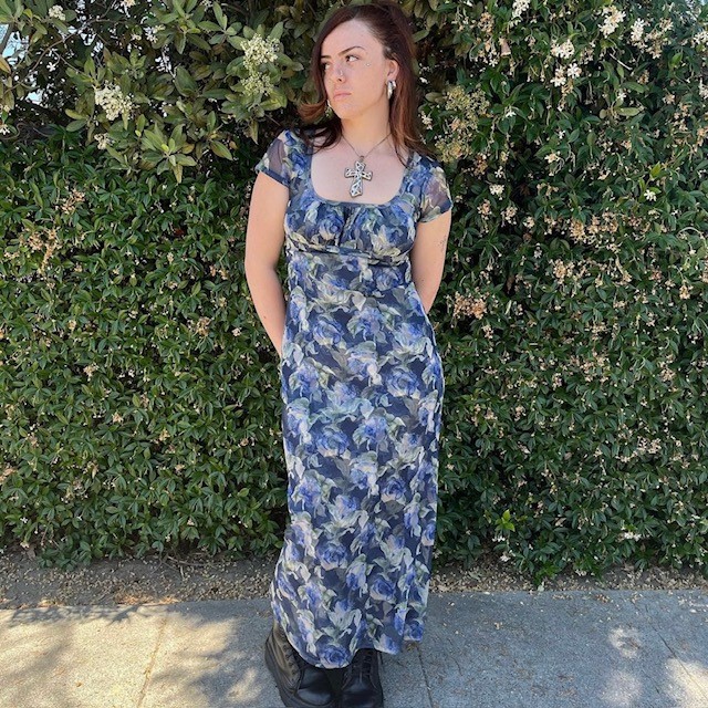 woman in long secondhand dress with purple floral print