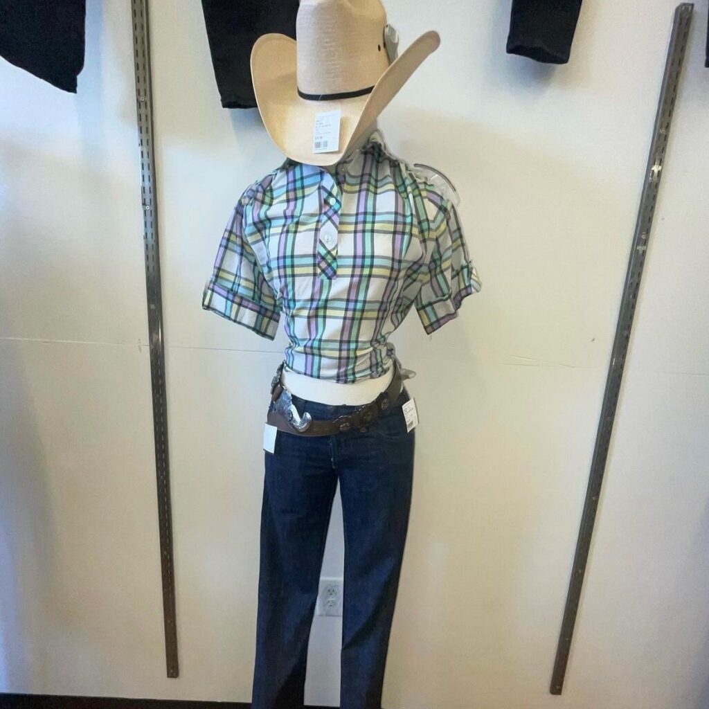 mannequin wearing a cowboy hat, western-style shirt, and jeans