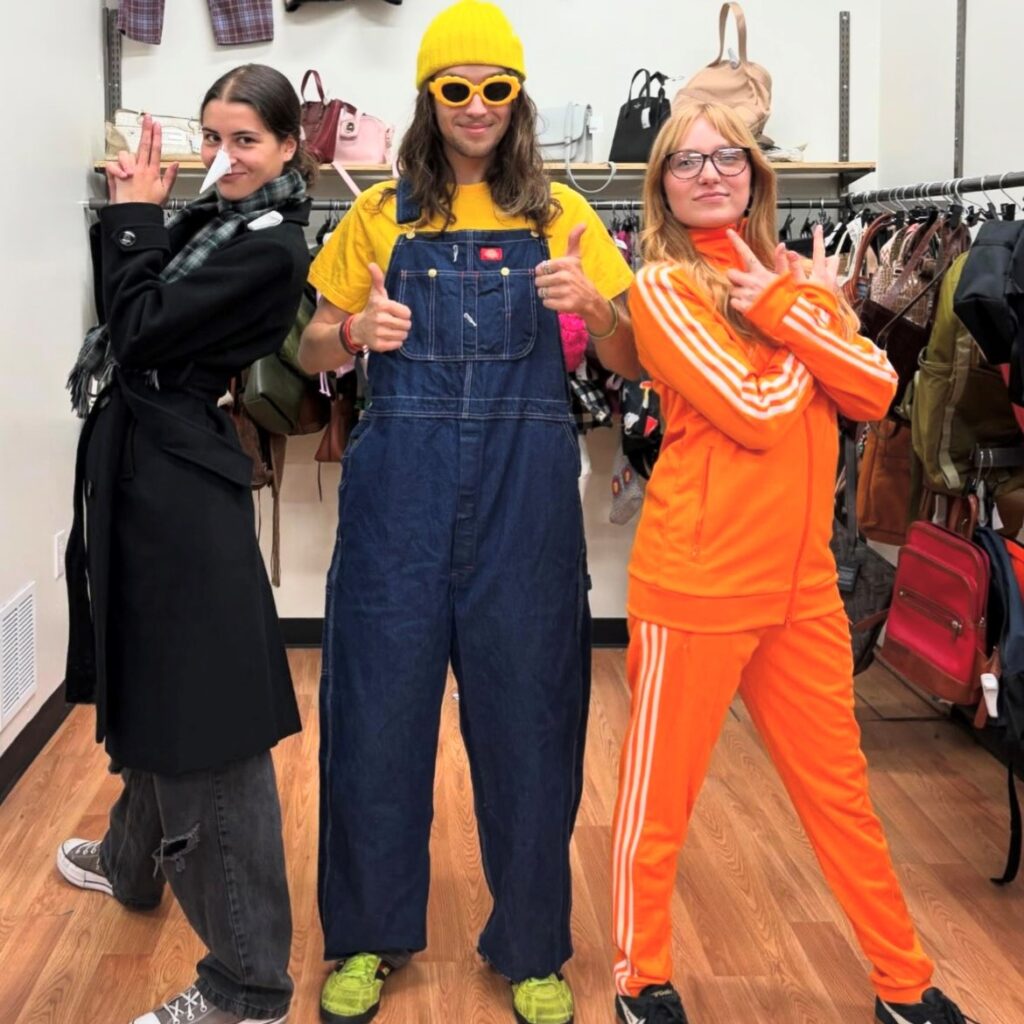 three people wearing thrift store Halloween costumes, dressed as Minions characters