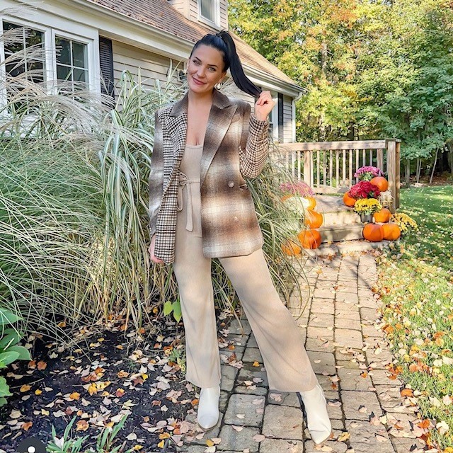 woman wearing a beige jumpsuit with flannel blazer