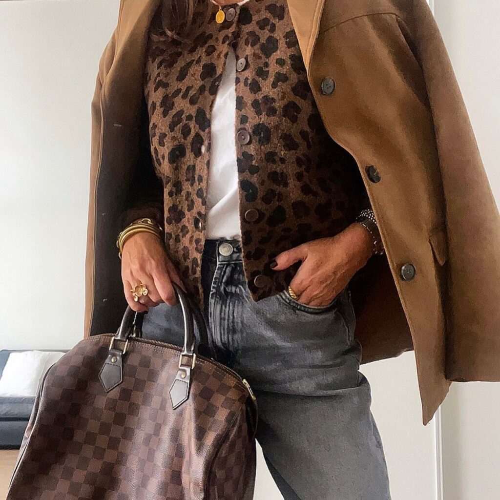 woman in leopard cardigan with white tee and jeans