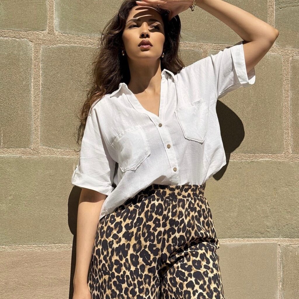 woman in white blouse and animal print pants