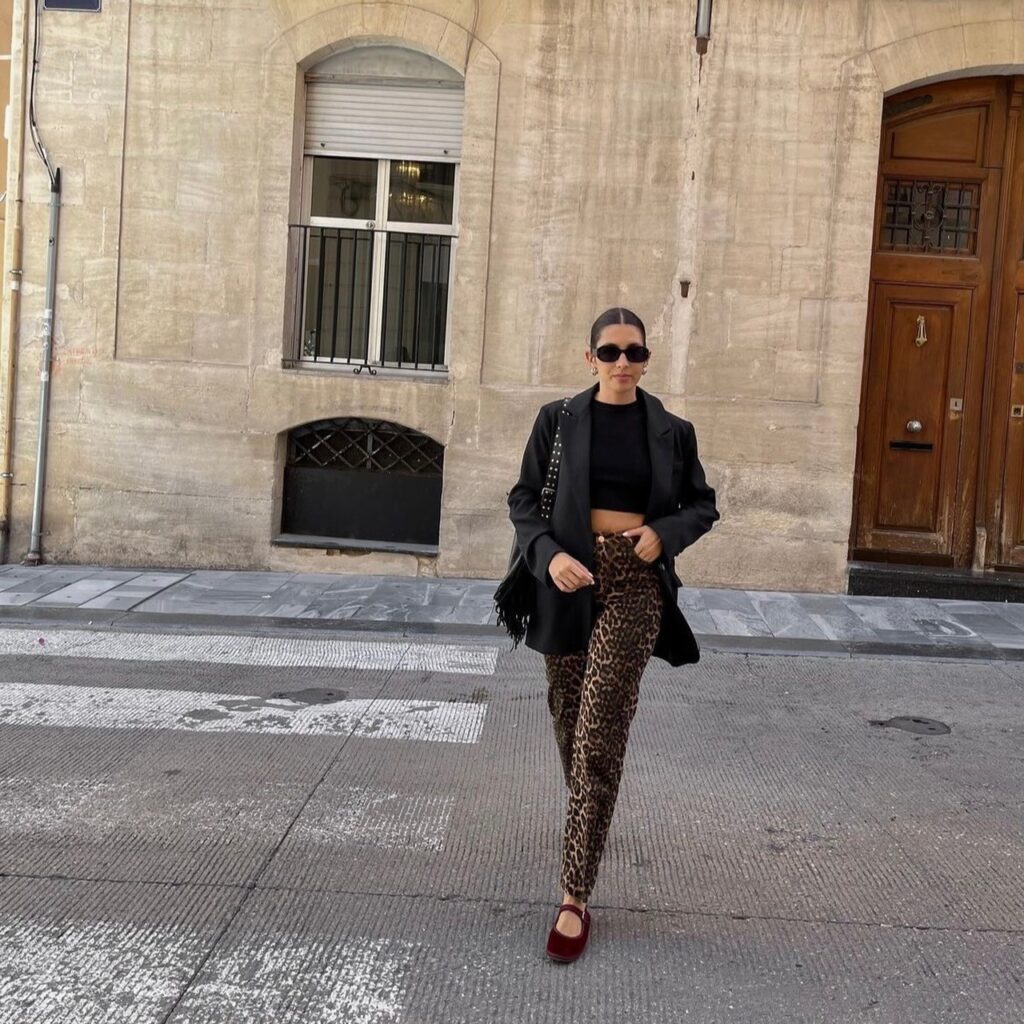 woman in leopard pants, black crop tee and black blazer