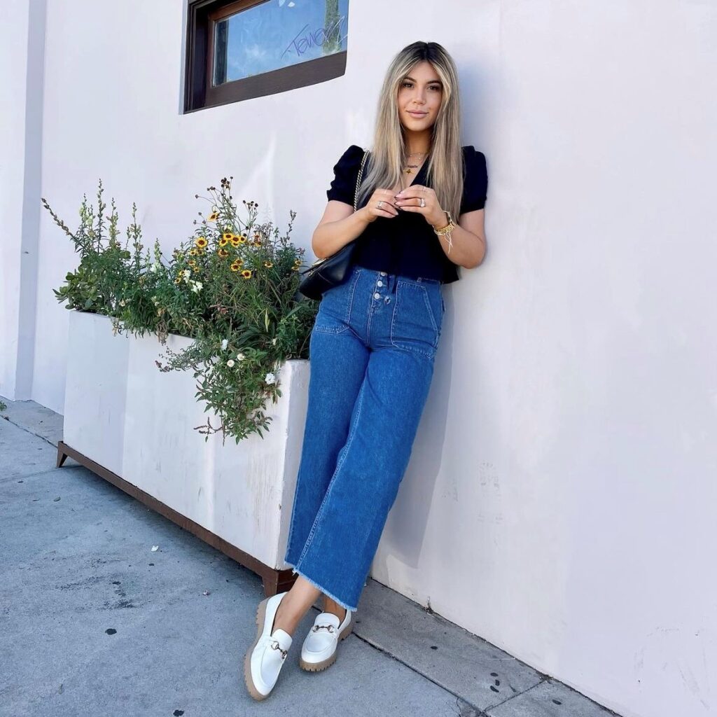 woman wearing a pair in white, with jeans and a black top