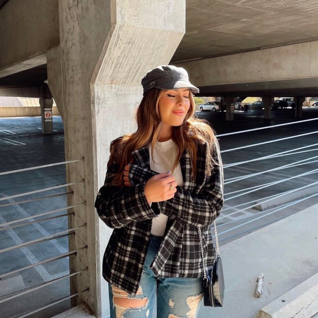 woman wearing a flannel shirt with distressed jeans and a white t-shirt