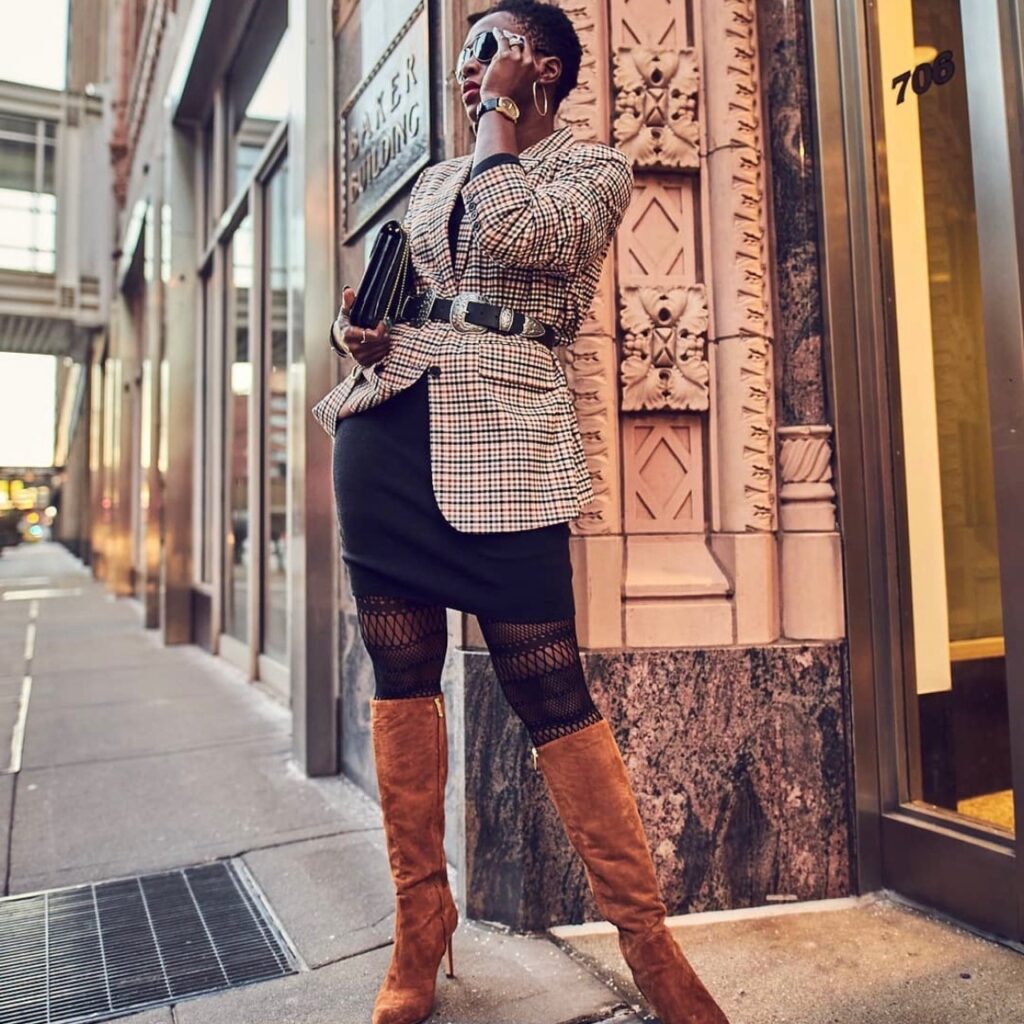 woman in checked blazer, black skirt and suede tall boots