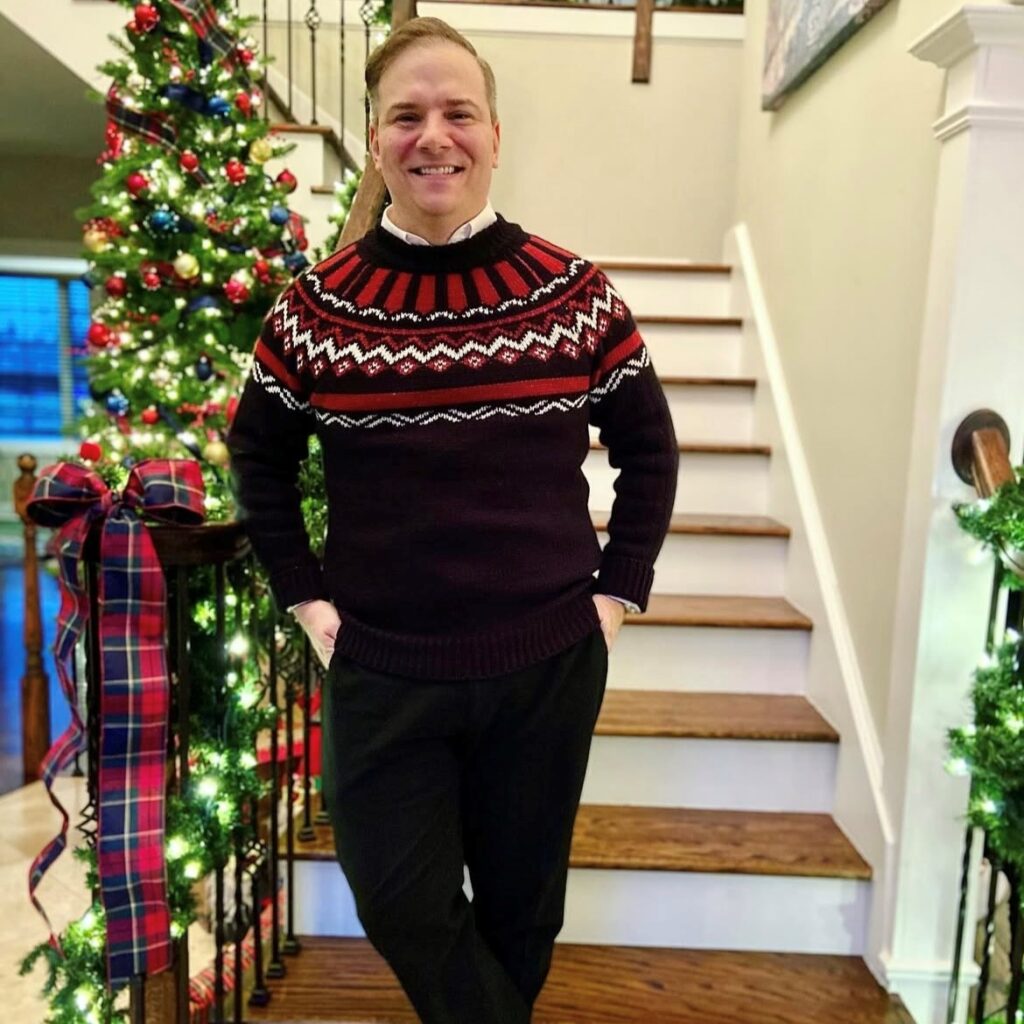 man wearing a fair isle sweater with trousers