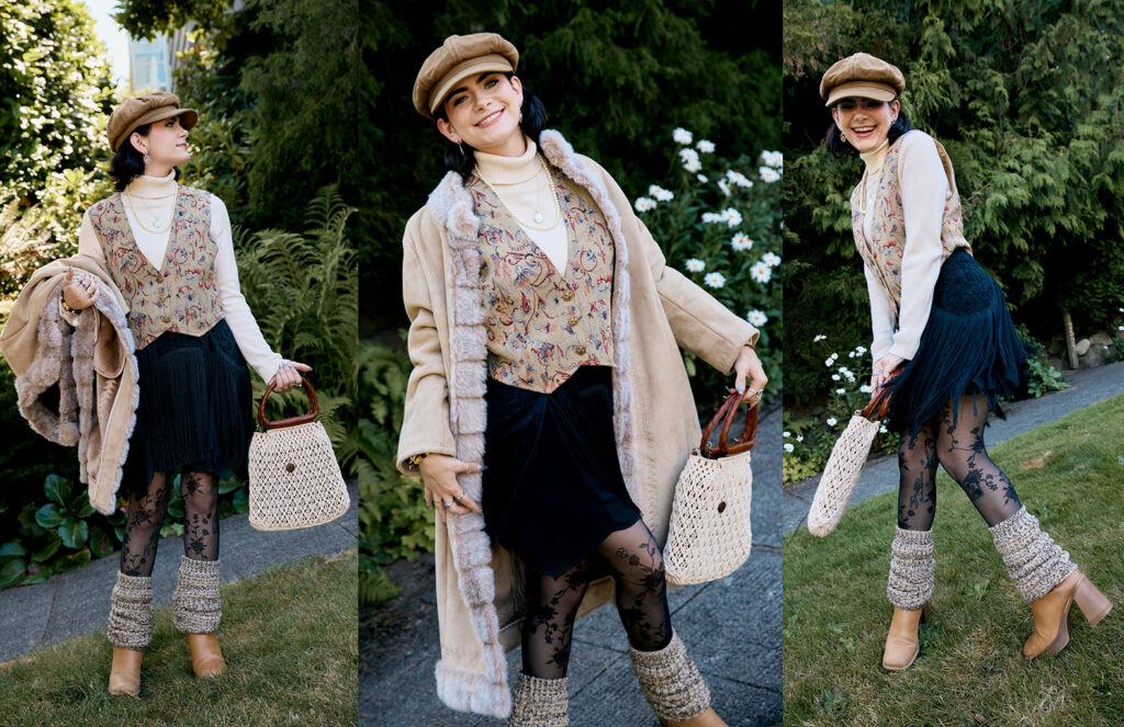 Renee wearing 70s inspired fashion, penny lane coat, floral vest, white turtleneck, fringe skirt in black, lace tights beige legwarmers and brown boots