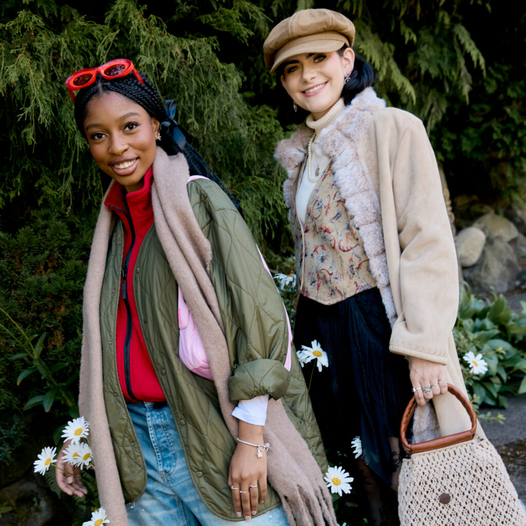 Tonoya and Renee wearing winter fashion standing in a flower bed