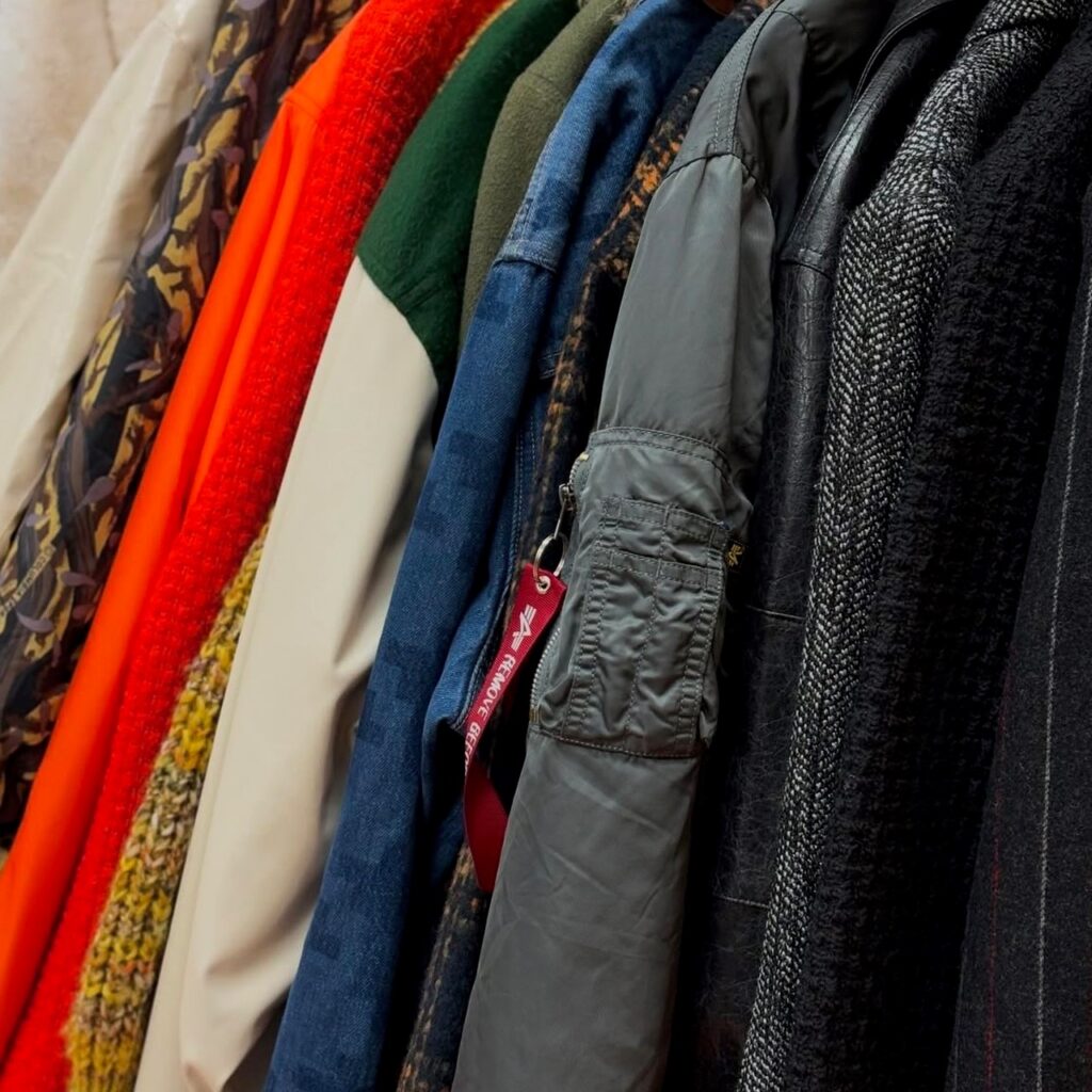 a rack of jackets in a secondhand store