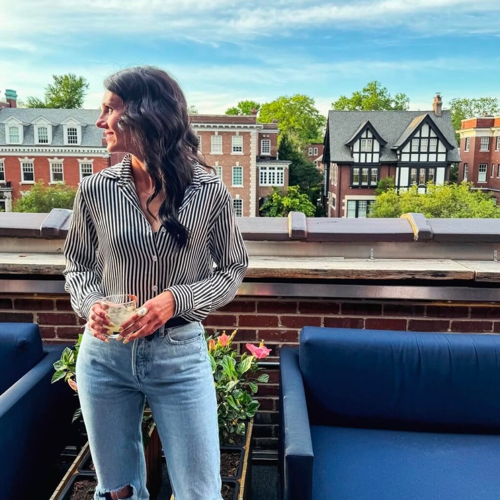 woman in striped blouse and distressed denim