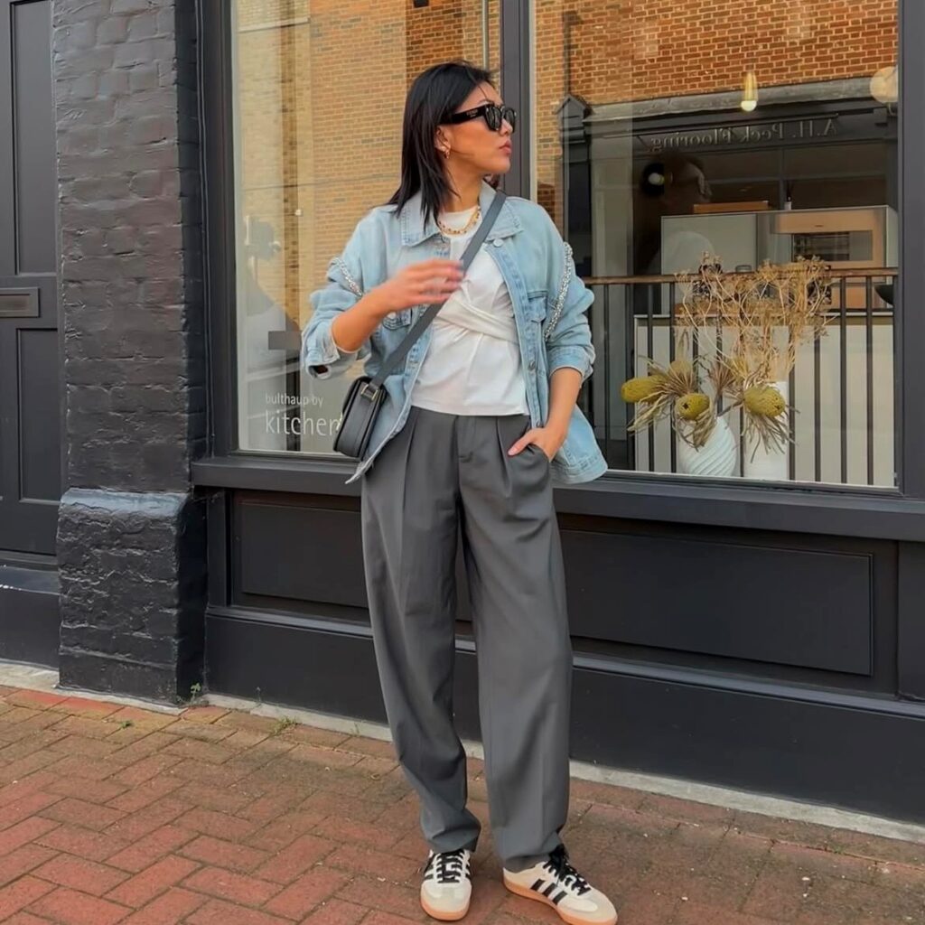 woman in denim jacket, white t-shirt, and gray pants