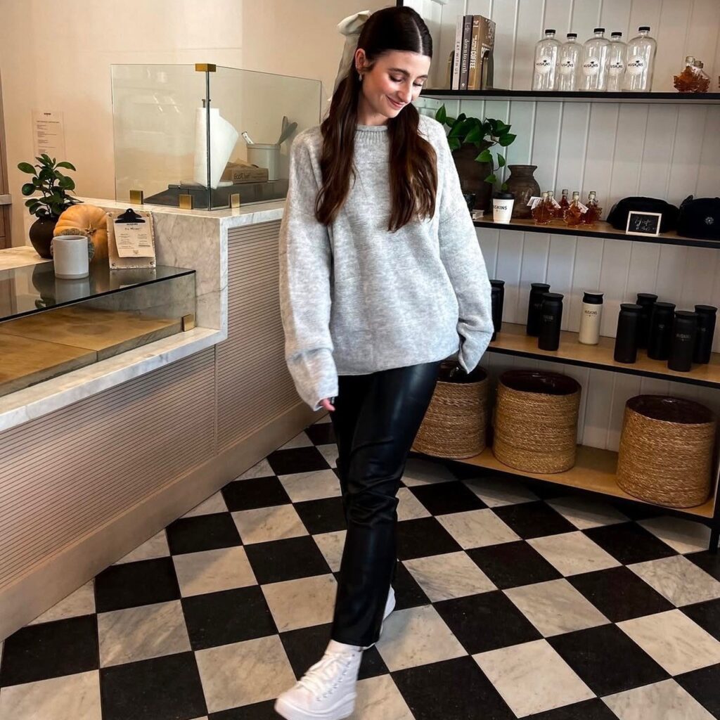 woman with black pair and gray sweater