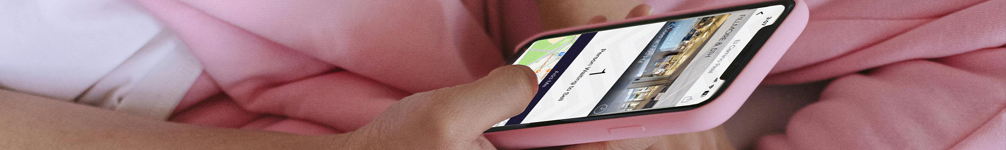photo of hands holding phone and using app
