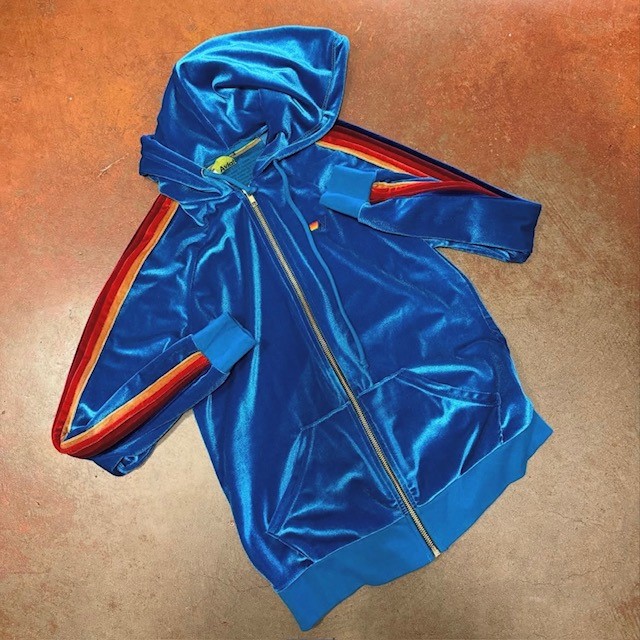 a thrifted blue velour jacket with multi-color striping
