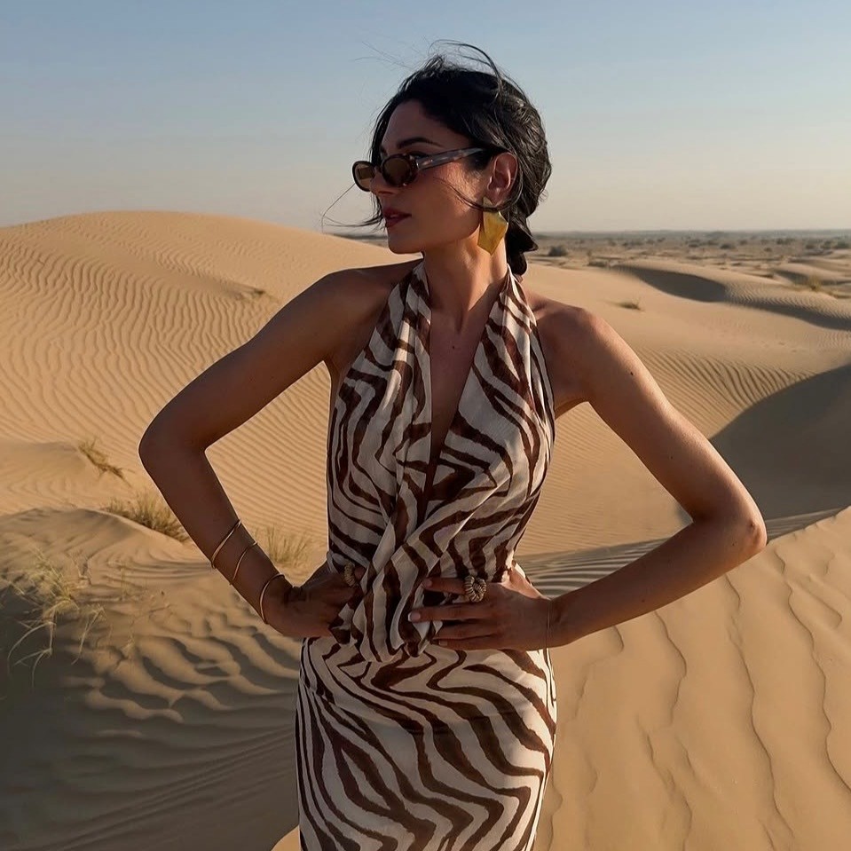 woman in sand and terracotta print halter dress