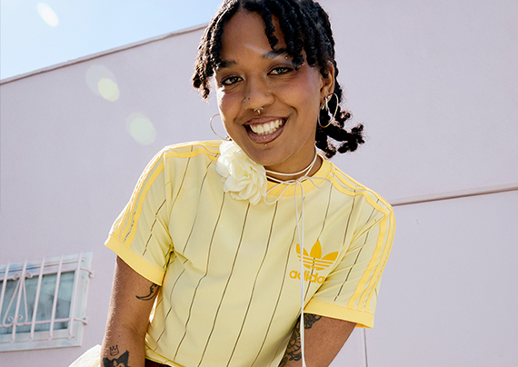Close up shot of Sage wearing a yellow soccer jersey and a white flower choker