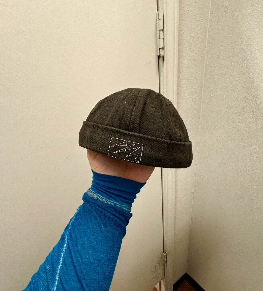 brimless cap that represents spring trends in men's fashion
